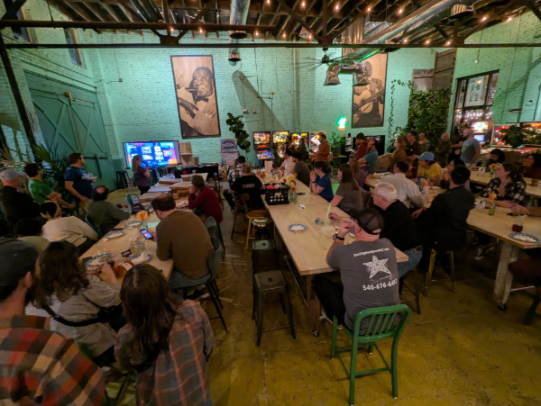 People at the Kickstarter Launch Party at Golden Cactus Brewing watch the presentation on our Kickstarter campaign